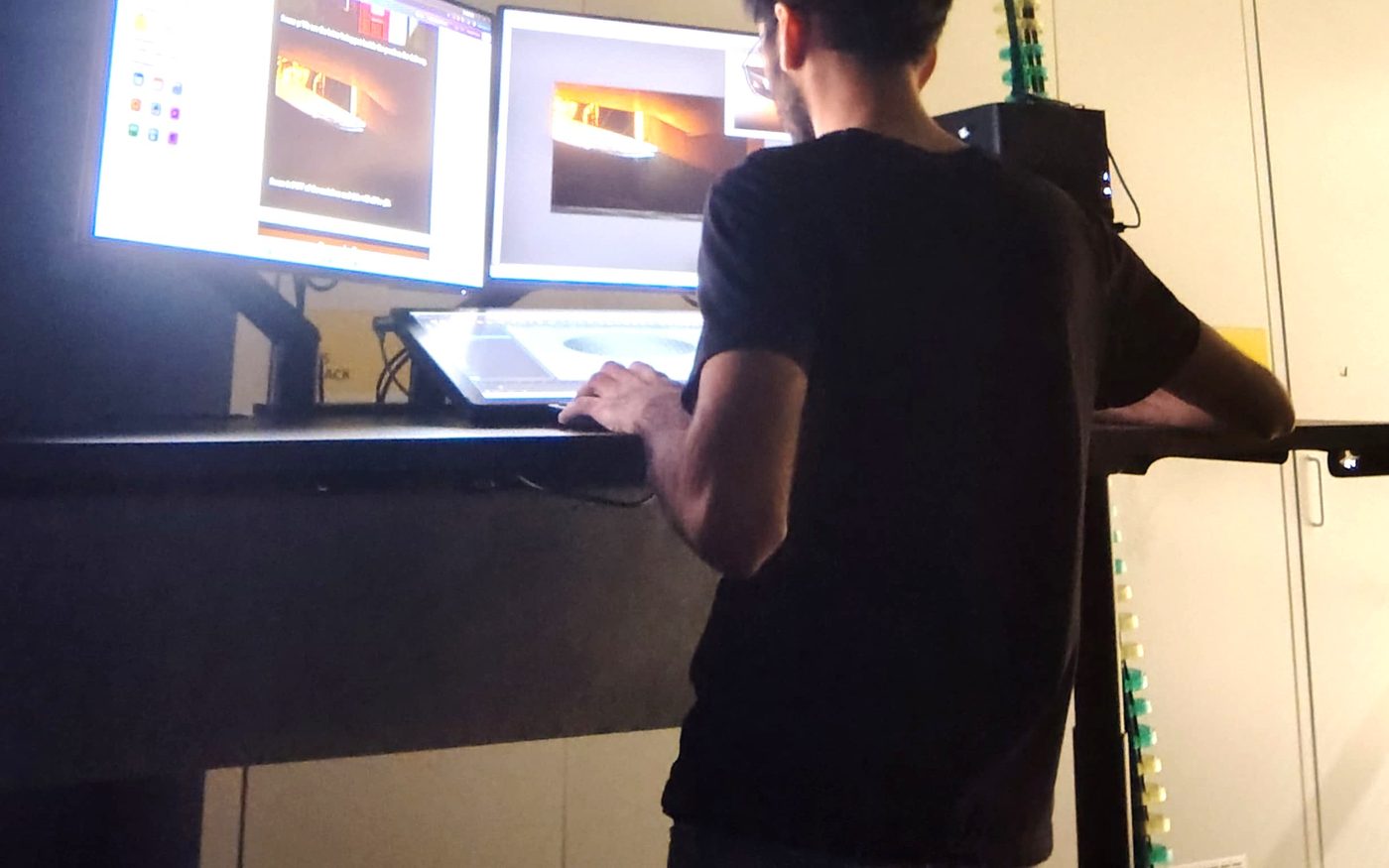 Jagreuben working at a multi-monitor VFX workstation at UNSW Sydney